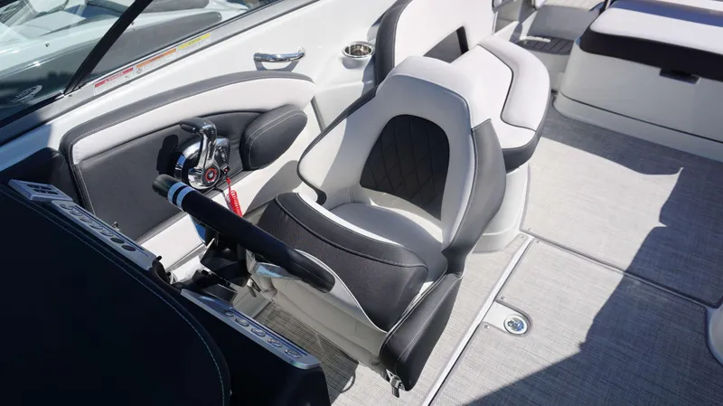 Slide: The Image of 2024 Crownline 290 XSS boat cockpit with modern helm and comfortable seating. - 21