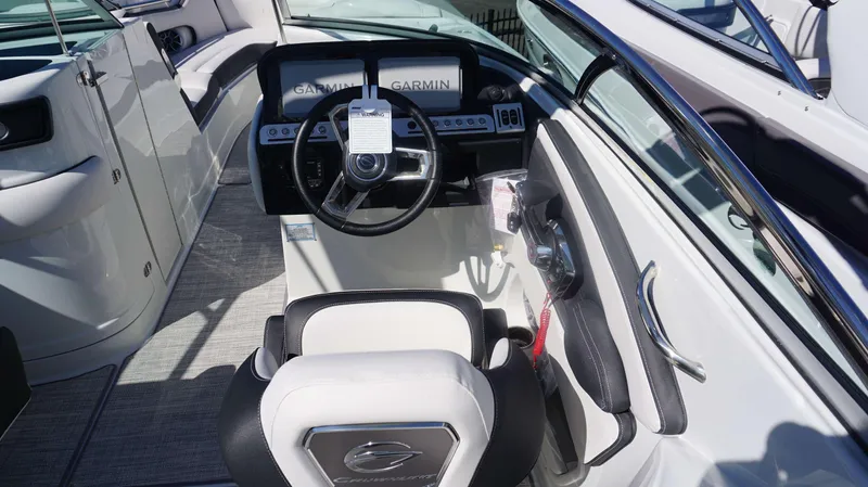 Slide: The Image of 2024 Crownline 290 XSS boat cockpit with Garmin navigation system. - 23