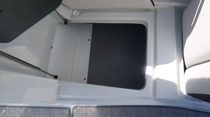 Slide: The Image of 2024 Crownline 290 XSS storage compartment with open hatch. - 4