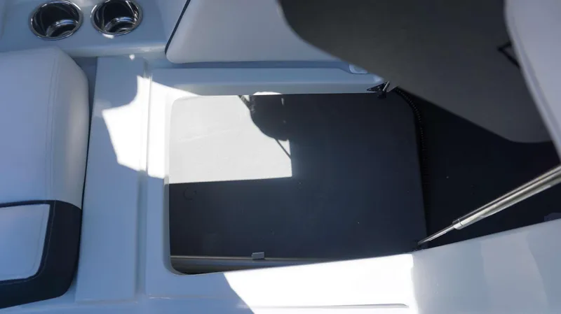 Slide: The Image of Storage compartment in the 2024 Crownline 290 XSS boat with cup holders. - 6