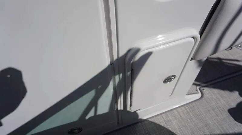 Slide: The Image of Close-up of 2024 Crownline 290 XSS boat's white storage compartment. - 8