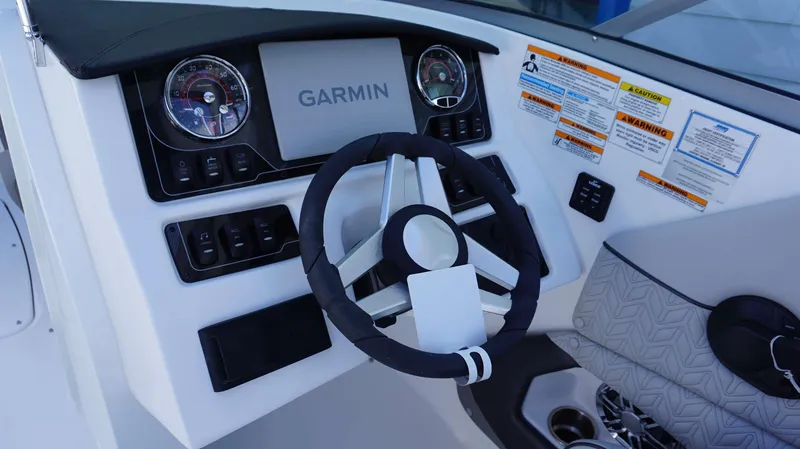 Slide: The Image of 2024 Hurricane 2690 SD boat dashboard with Garmin navigation system and steering wheel. - 10