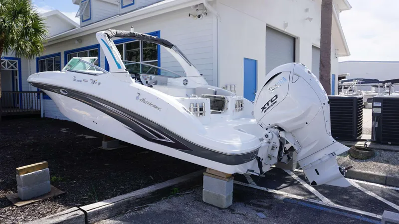 Slide: The Image of 2024 Hurricane 2690 SD boat on display outside a building. - 12