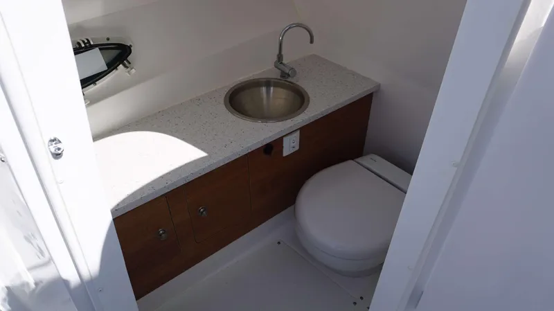 Slide: The Image of 2024 Hurricane 2690 SD boat bathroom with sink and toilet. - 13