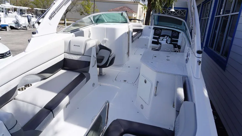 Slide: The Image of 2024 Hurricane 2690 SD boat interior with seating, helm, and storage compartments. - 17