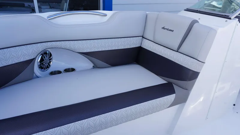 Slide: The Image of 2024 Hurricane 2690 SD boat interior seating with speaker and cup holders. - 20