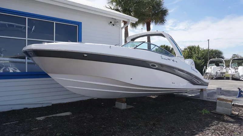 Slide: The Image of 2024 Hurricane 2690 SD boat displayed on blocks outside a showroom. - 23