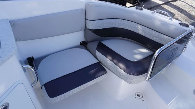 Slide: The Image of 2024 Hurricane 2690 SD boat seating area with cushioned seats and cup holders. - 5