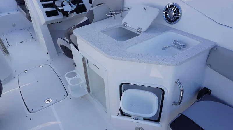 Slide: The Image of 2024 Hurricane 2690 SD boat interior with sink, storage, and steering console. - 7