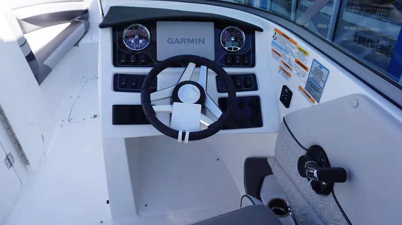 Slide: The Image of 2024 Hurricane 2690 SD boat dashboard with Garmin navigation system and steering wheel. - 9