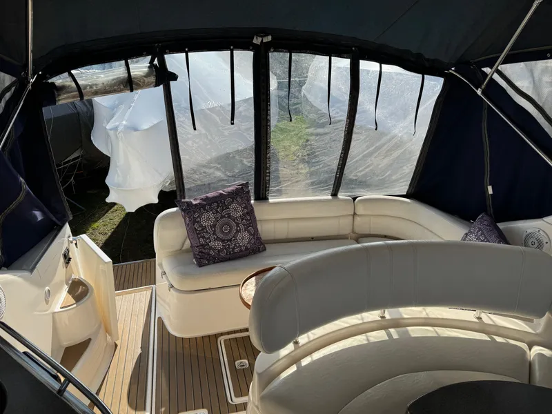 Slide: The Image of Interior of 2007 Regal 4060 COMMODORE yacht with white seating and decorative pillows. - 14