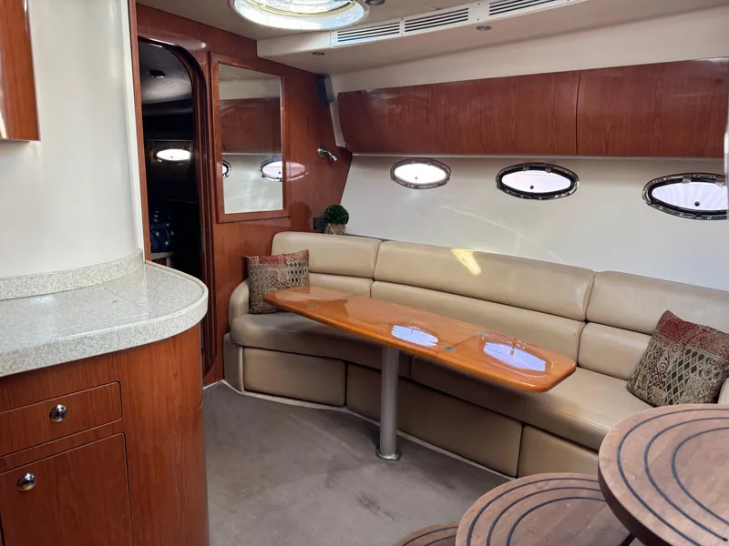 Slide: The Image of Interior of 2007 Regal 4060 COMMODORE yacht with beige leather seating and wooden accents. - 15