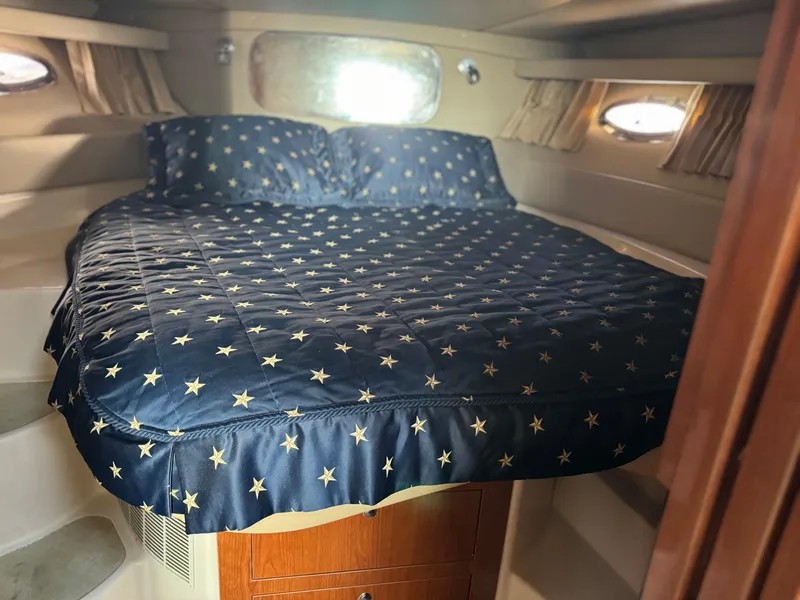 Slide: The Image of Luxurious bedroom in 2007 Regal 4060 COMMODORE yacht with star-patterned bedding. - 17