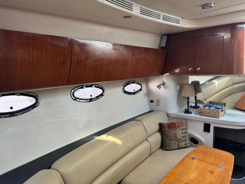 Slide: The Image of Interior of 2007 Regal 4060 COMMODORE yacht with beige seating and wooden cabinets. - 19
