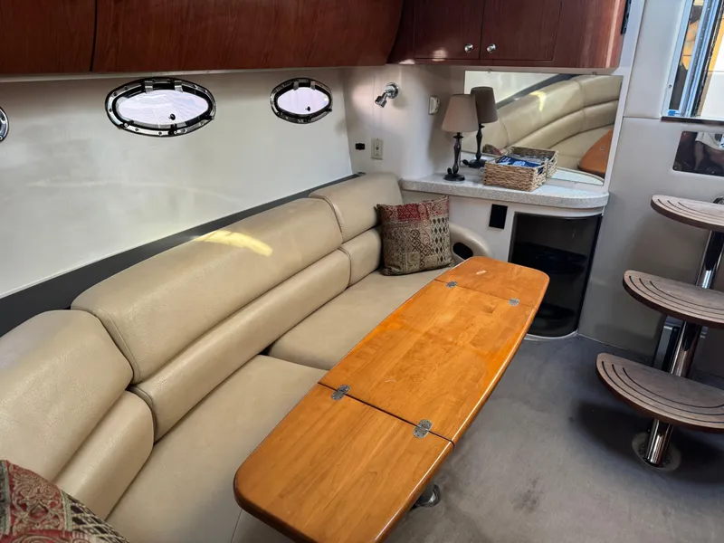Slide: The Image of Interior of 2007 Regal 4060 COMMODORE yacht with beige leather seating and wooden table. - 20