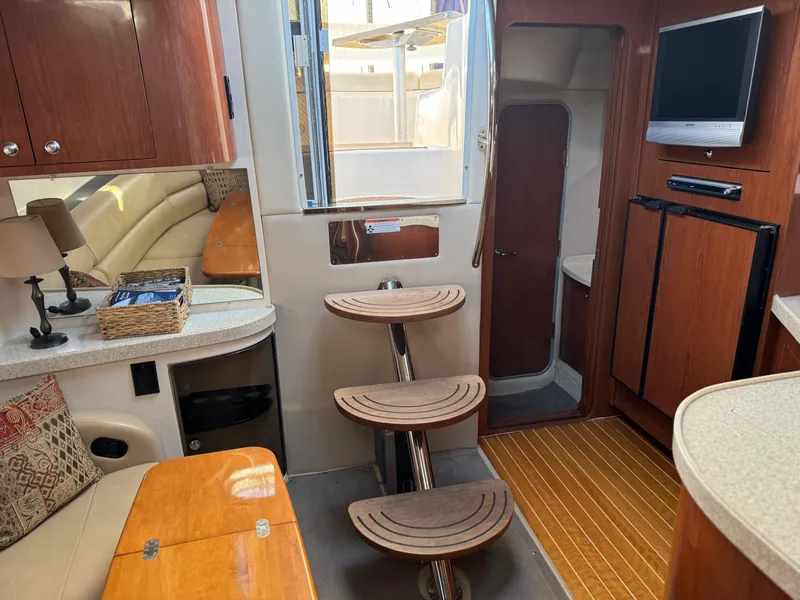 Slide: The Image of Interior of 2007 Regal 4060 COMMODORE yacht with wooden cabinetry and modern amenities. - 21