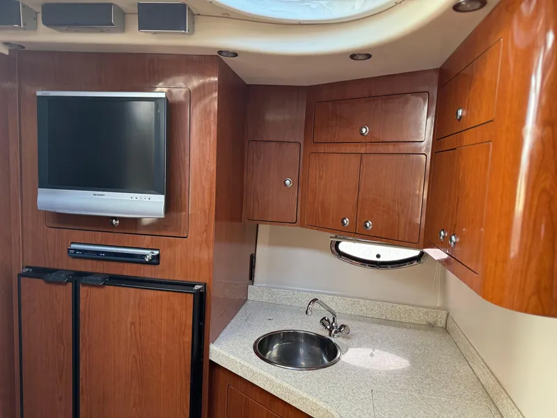 Slide: The Image of 2007 Regal 4060 COMMODORE yacht interior with kitchenette and TV. - 23