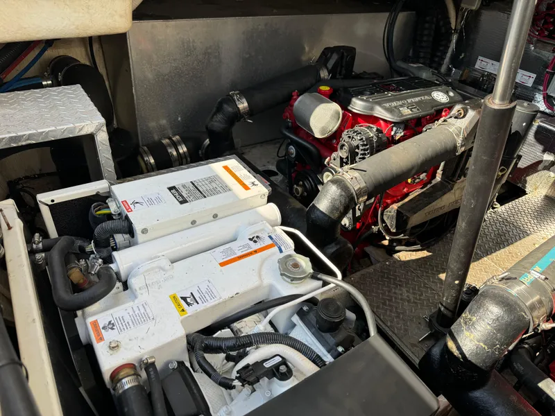 Slide: The Image of Engine compartment of a 2007 Regal 4060 COMMODORE boat showing batteries and engine components. - 28