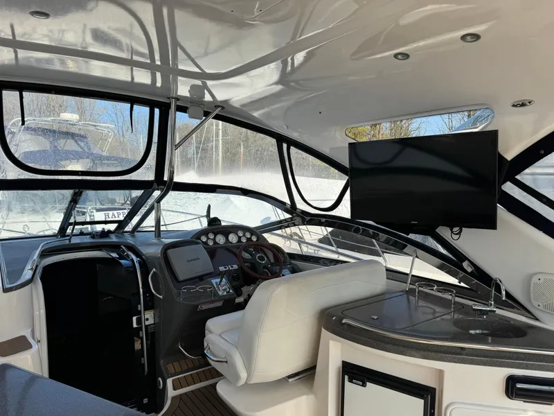 Slide: The Image of Interior of 2007 Regal 4060 COMMODORE yacht with helm, seating, and TV. - 5