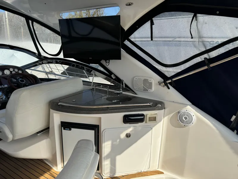 Slide: The Image of 2007 Regal 4060 COMMODORE yacht interior with TV, mini-fridge, and seating. - 6