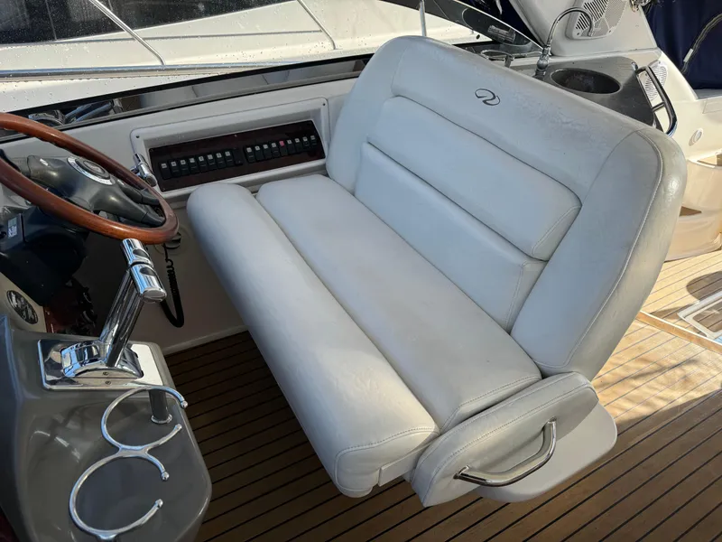 Slide: The Image of 2007 Regal 4060 COMMODORE helm seat and steering wheel on teak deck. - 9