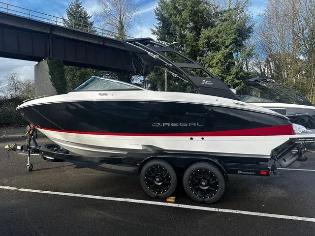 Slide: The Image of 2024 Regal LS4 boat on a trailer under a bridge, side view. - 3