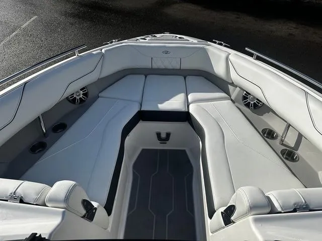 Slide: The Image of 2024 Regal LS4 boat interior with white cushioned seating and cup holders. - 8