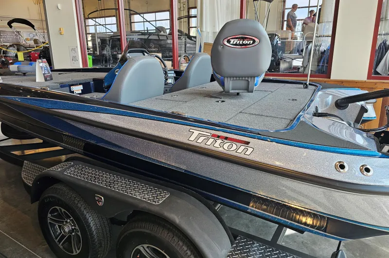 Slide: The Image of 2024 Triton 19 TrX boat in showroom, featuring sleek design and dual seats. - 2