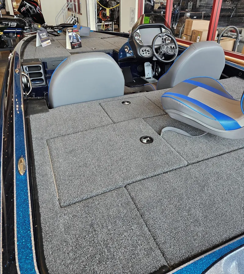 Slide: The Image of 2024 Triton 19 TrX boat interior with gray carpet and modern dashboard. - 3