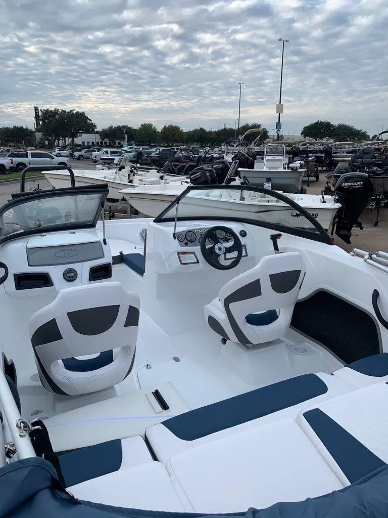 Slide: The Image of 2024 Tahoe 185 S boat interior with modern seating and dashboard. - 2