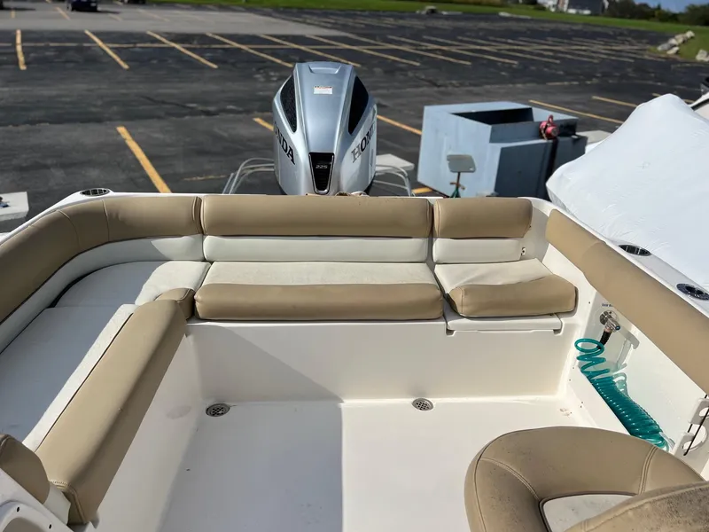 Slide: The Image of 2020 Key West 239 DFS boat with cushioned seating and Honda outboard motor. - 12