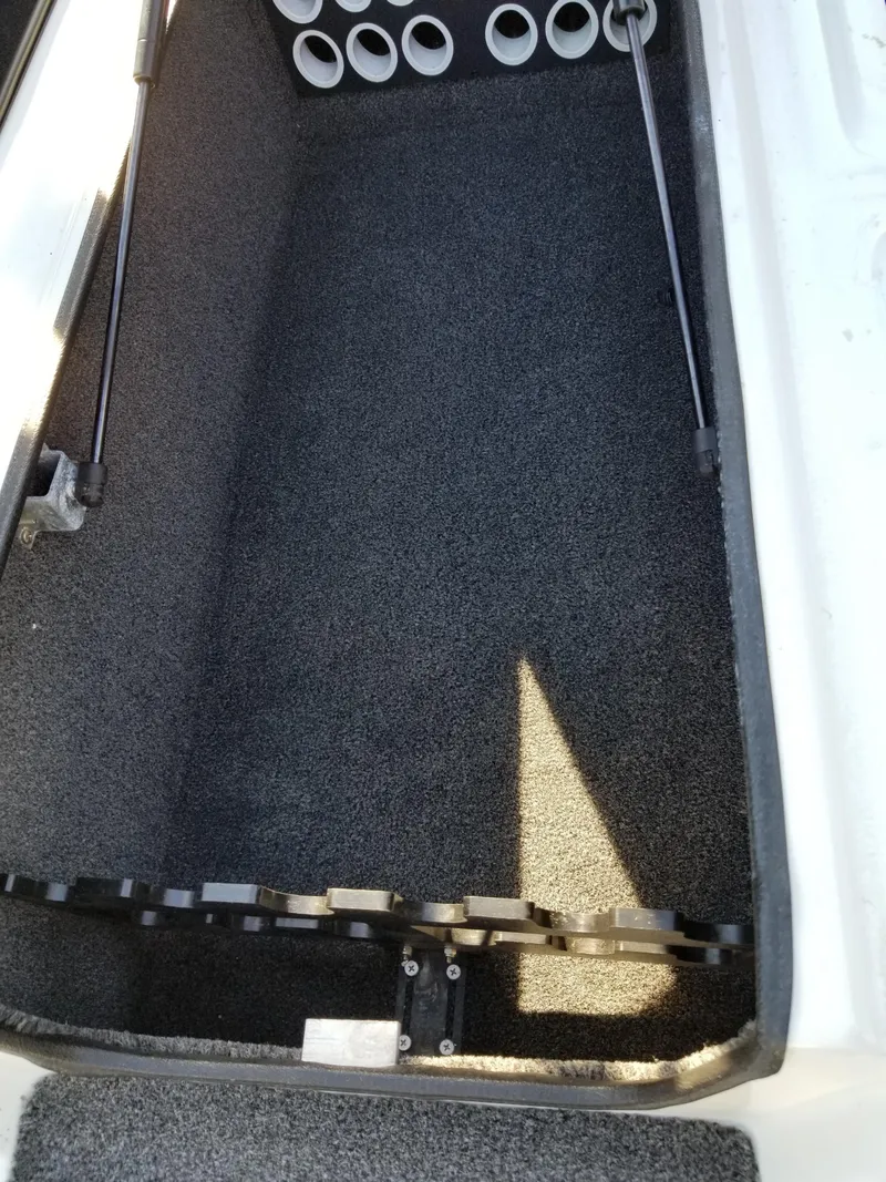 Slide: The Image of 2014 Legend Boats ALPHA 191 SCX storage compartment with rod holders. - 15