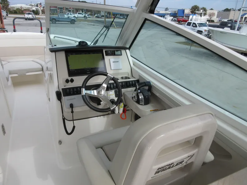 Slide: The Image of 2021 Boston Whaler 280 Vantage boat helm with steering wheel and navigation system. - 10