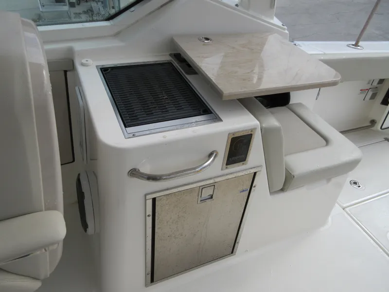 Slide: The Image of 2021 Boston Whaler 280 Vantage boat interior with grill and seating area. - 19