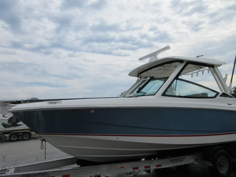 Slide: The Image of 2021 Boston Whaler 280 Vantage boat on a trailer under a cloudy sky. - 3