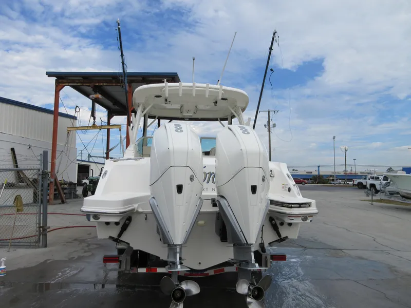 Slide: The Image of 2021 Boston Whaler 280 Vantage with twin outboard engines at a marina. - 4