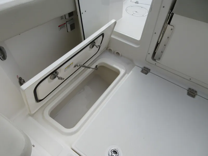 Slide: The Image of 2021 Boston Whaler 280 Vantage storage compartment open on deck. - 6