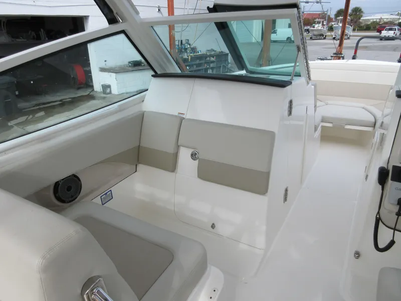 Slide: The Image of 2021 Boston Whaler 280 Vantage boat interior with seating and windshield. - 9