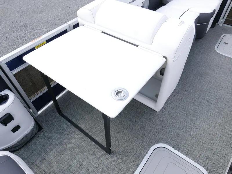Slide: The Image of 2024 Barletta Corsa 23UC boat interior with white table and seating. - 15