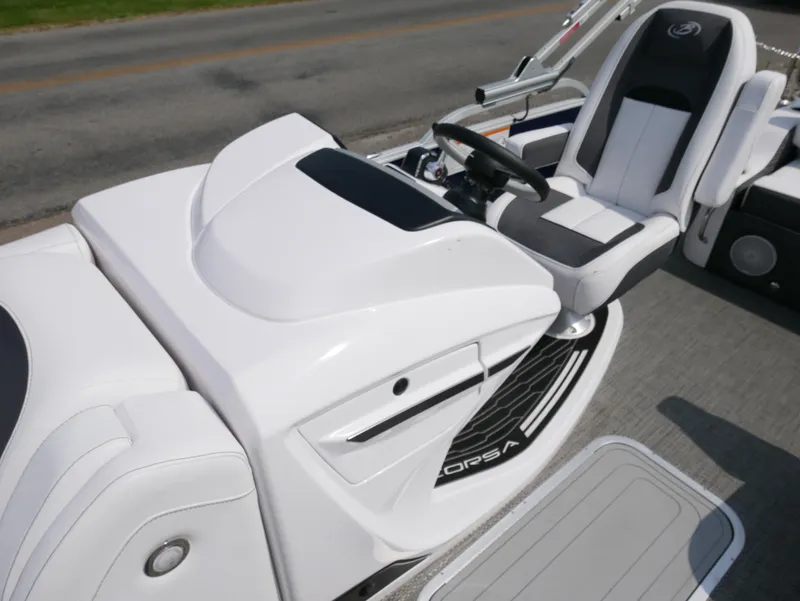 Slide: The Image of 2024 Barletta Corsa 23UC boat interior with sleek white seating and modern dashboard. - 17