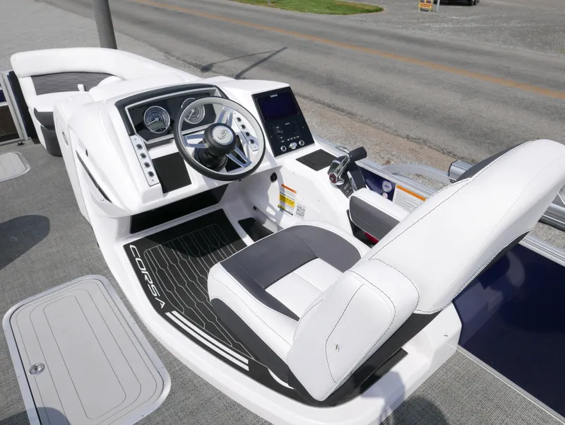Slide: The Image of 2024 Barletta Corsa 23UC boat interior with modern dashboard and steering wheel. - 18