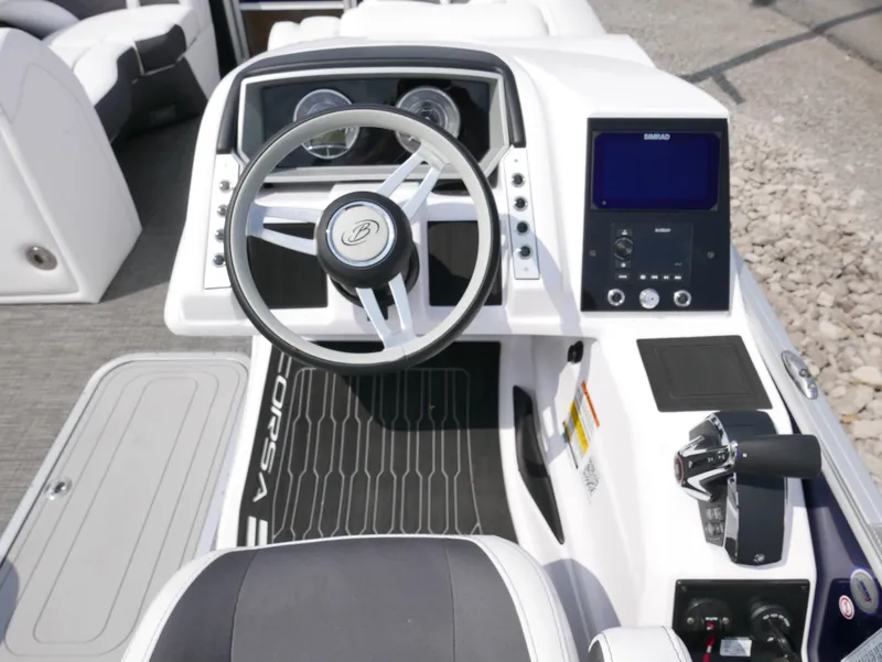 Slide: The Image of 2024 Barletta Corsa 23UC boat dashboard with steering wheel and control panel. - 19