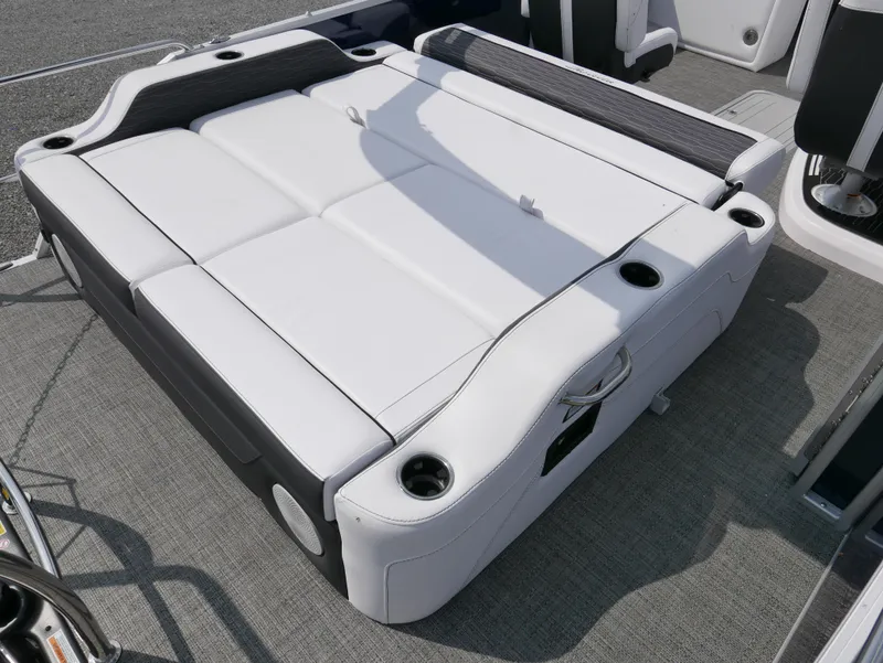 Slide: The Image of 2024 Barletta Corsa 23UC boat interior with white cushioned seating and cup holders. - 24