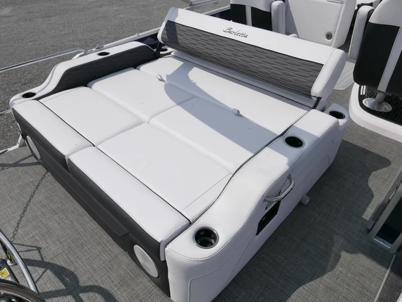 Slide: The Image of 2024 Barletta Corsa 23UC boat seating area with cup holders and cushioned layout. - 28