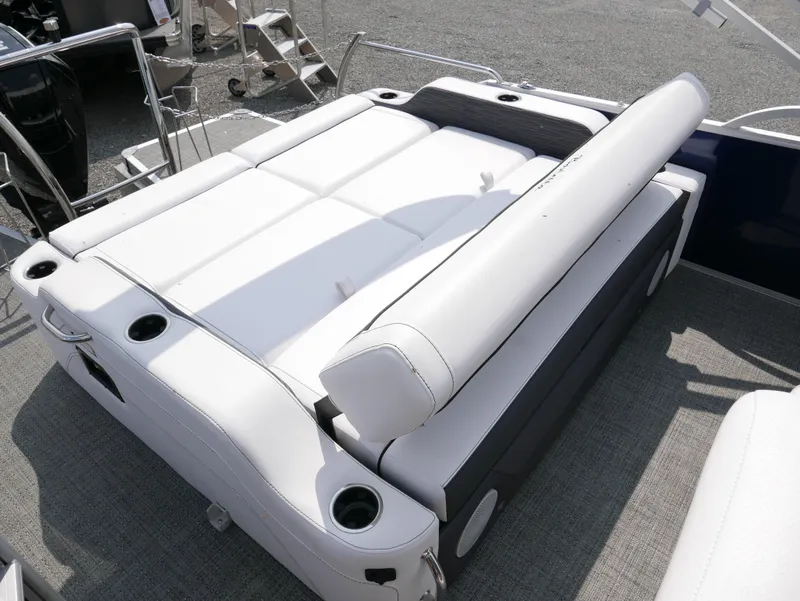 Slide: The Image of 2024 Barletta Corsa 23UC boat interior with white cushioned seating and cup holders. - 29
