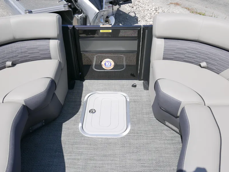 Slide: The Image of 2024 Barletta Corsa 23UC boat interior with gray seating and carpeted floor. - 12