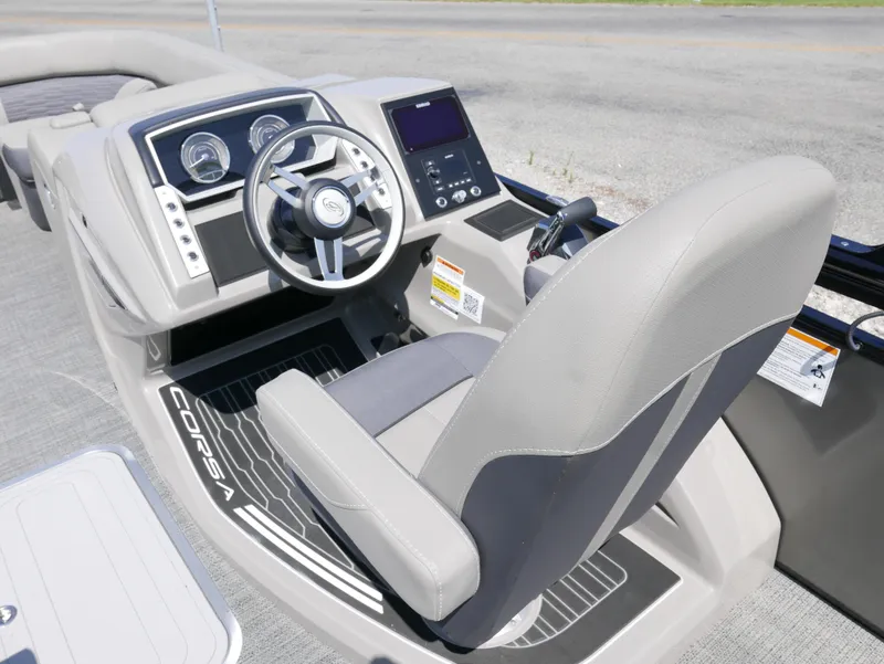 Slide: The Image of 2024 Barletta Corsa 23UC boat helm with modern steering and dashboard controls. - 18