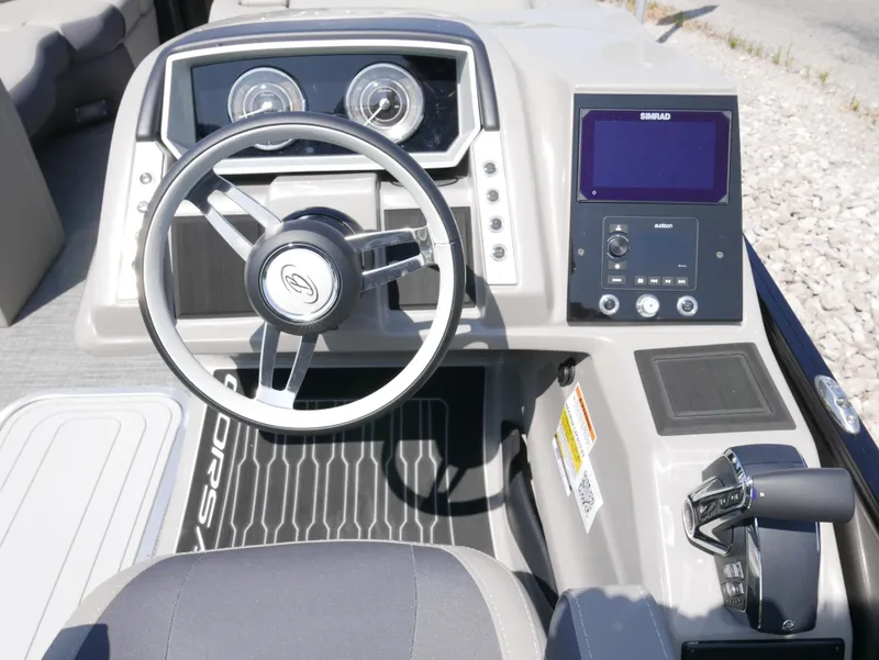Slide: The Image of 2024 Barletta Corsa 23UC boat dashboard with steering wheel and control panel. - 19