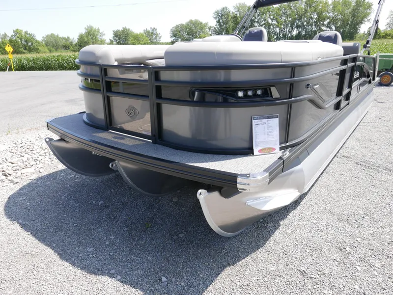 Slide: The Image of 2024 Barletta Corsa 23UC pontoon boat on gravel, showcasing sleek design and modern features. - 2