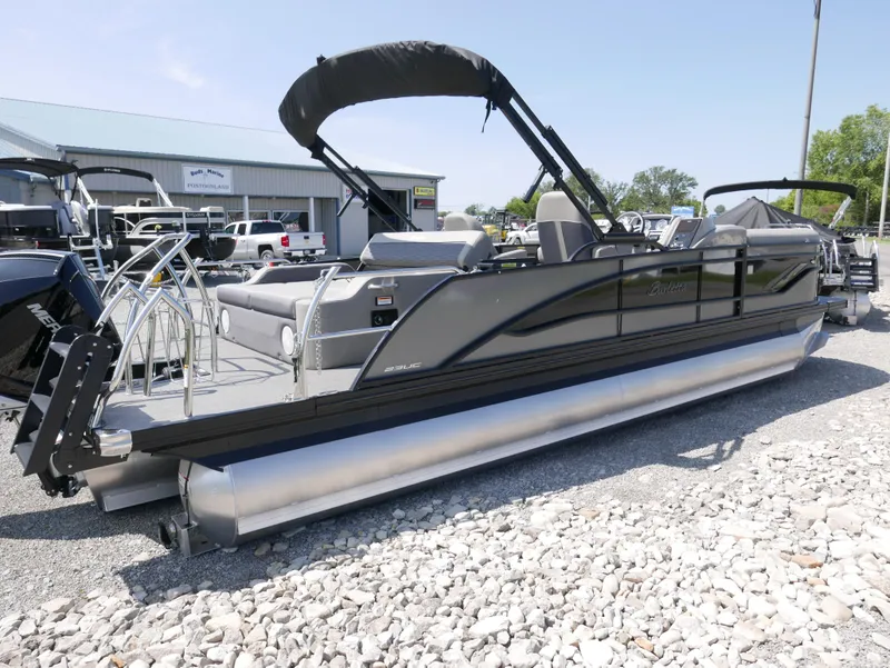 Slide: The Image of 2024 Barletta Corsa 23UC pontoon boat on gravel lot, side view. - 5